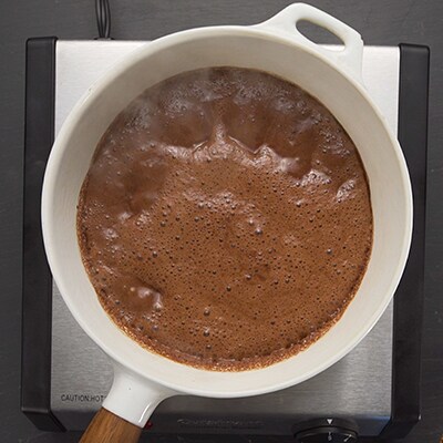 A pot of melted ice cream on stove