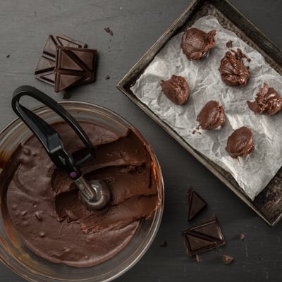 6 scoops of ganache being scooped onto a pan
