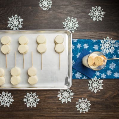 Step 6 Dipping the frozen snowmen into the melted chocolate